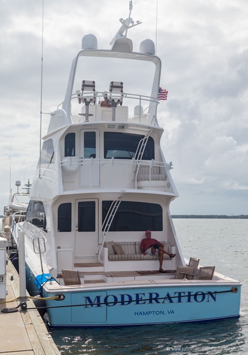 Sport fishing boat tied up to floating dock