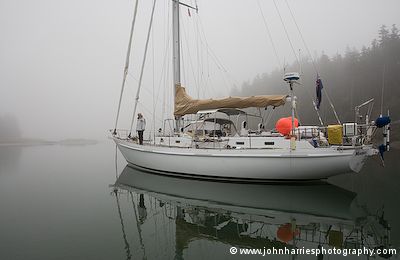 Aluminum expedition sailboat Morgan's Cloud lies at anchor in The Mud Hole, Maine