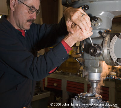 David, machinist at Billings Diesel & Marine, uses a drill press on a stainless steel block