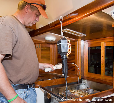 A professional gas technician tests the Force10 stove (cooker) for gas leaks on aluminum expedition sailboat Morgan's Cloud