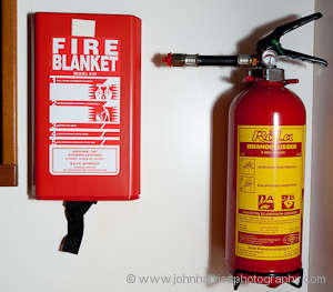 A one-time-use-only fire blanket and fire extinguisher on Polaris, an aluminum expedition sailboat