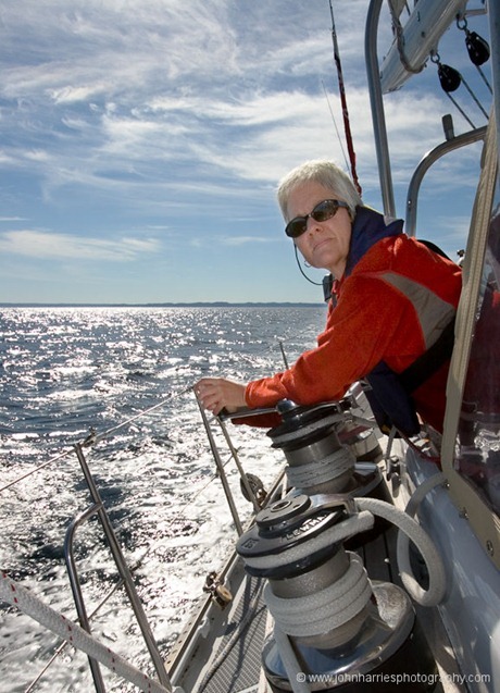 Phyllis Nickel takes a turn on the jib sheet during a sunny summer afternoon off the east coast of Newfoundland, Canada. Phyllis Nickel takes a turn on the jib sheet during a sunny summer afternoon off the east coast of Newfoundland, Canada.