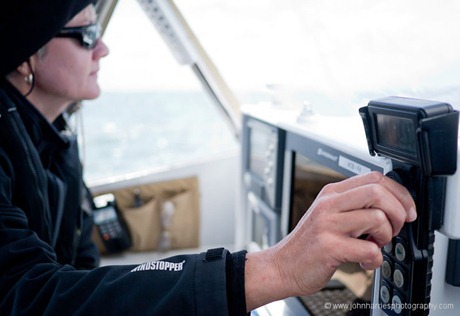 Phyllis adjusts autopilot control on sailboat Morgan's Cloud JHHG3-1000189