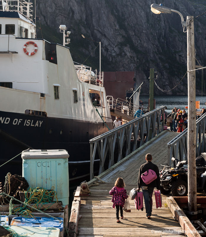A young girl and man leaving Francois on the ferry