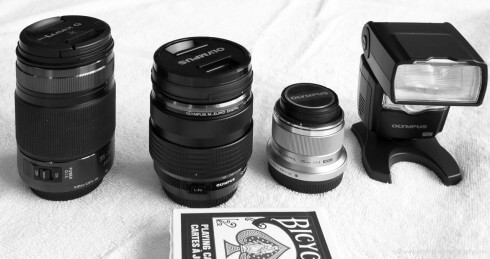 Camera lenses and flashes with deck of cards in forefront for scale JHHOMD1-1190355